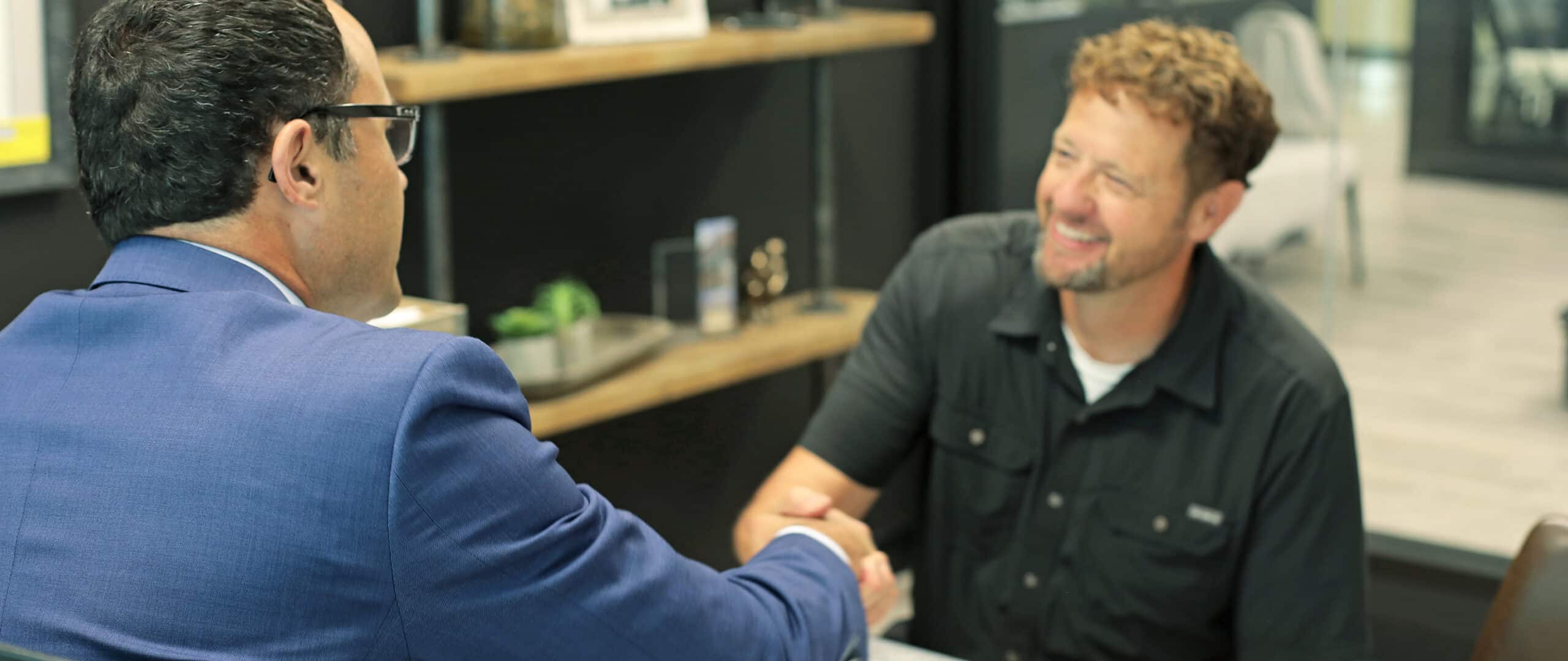 Happy client shaking hand of fiduciary investment advisor