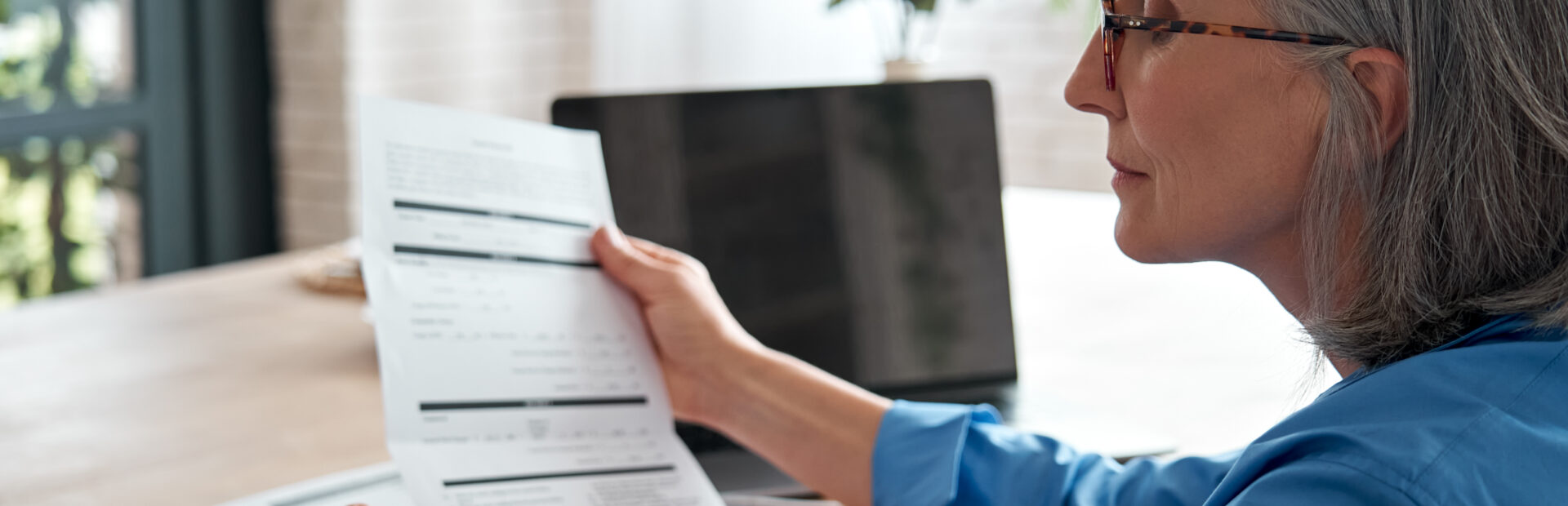 Older person looking at documents related to Retirement Wealth Management