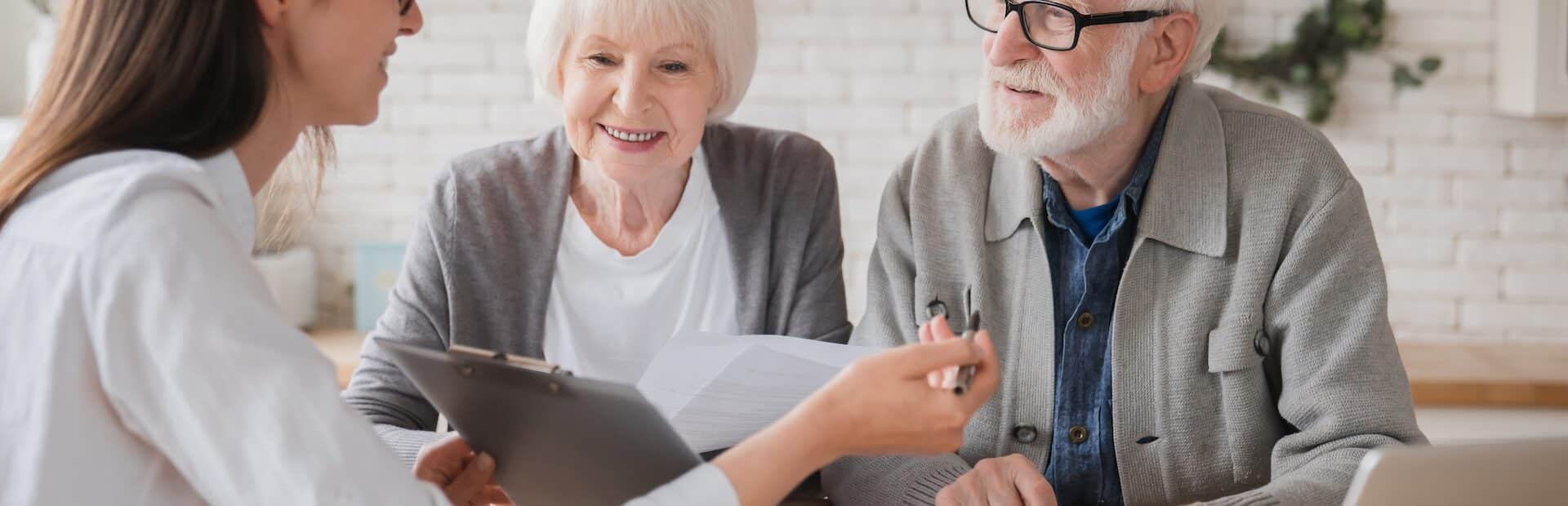 wealth manager helping elderly couple with financial planning