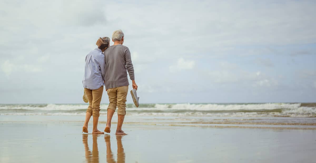 Elderly couple standing on a beach