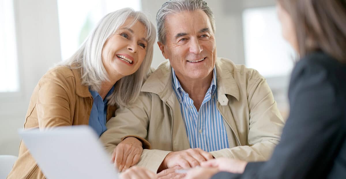 Elderly couple learning the difference of financial advisor vs wealth advisor