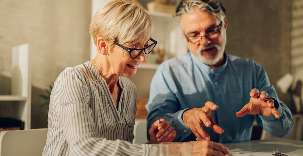 Elderly couple discussing retirement planning questions