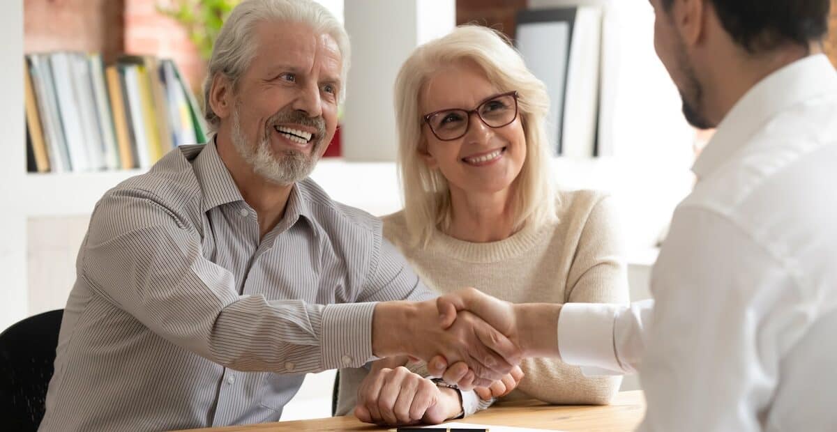 smiling couple receiving personalized wealth management